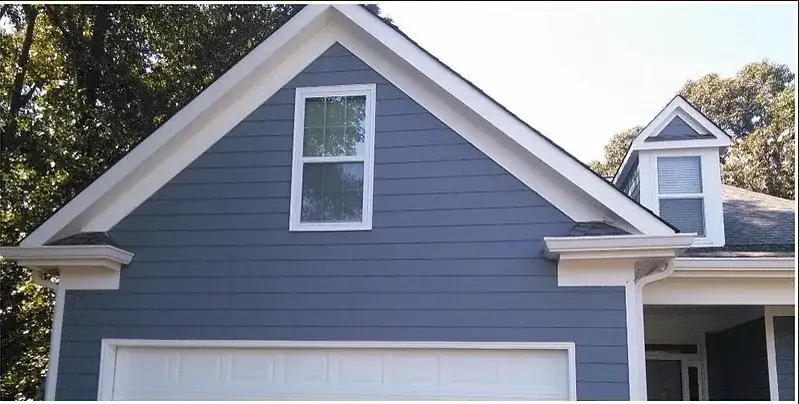 Fiber cement siding after photo showing new lap siding and trim